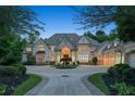 Stately home boasts a circular driveway, three-car garage, and meticulously maintained landscaping at 510 Covington Cv, Alpharetta, GA 30022