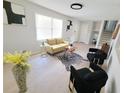 Bright living room with modern furnishings, light wood floors, and neutral decor at 208 Willows Ct, Riverdale, GA 30274