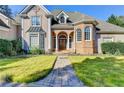 Elegant home entrance featuring arched doorways and stone walkway to the front door at 3871 River Mansion Dr, Peachtree Corners, GA 30096