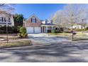 View of a charming two-story home with a brick facade, a long driveway, and well-maintained landscaping at 500 Sapphire Valley Ln, Canton, GA 30114