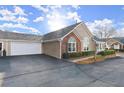 A well-maintained home featuring a two-car garage, an American flag, and manicured front yard at 938 Burnt Hickory Nw Cir, Marietta, GA 30064