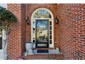 Close-up of an arched entryway with a black front door and decorative details at 4212 Lazy Creek Dr, Marietta, GA 30066