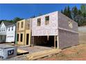New construction home showing framing, weatherproofing, and a two-car garage at 4300 Easter Lily Ave Lot 11, Buford, GA 30519