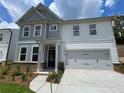 Exterior front view of a new two-story home with gray and white siding and a two-car garage at 4300 Easter Lily Ave Lot 11, Buford, GA 30519