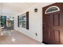 Welcoming front porch with a brown door and a security system at 510 Mountainview Dr, Covington, GA 30016