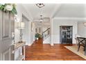 Elegant foyer with hardwood floors, neutral walls, and stylish light fixtures at 4675 Allistair Dr, Cumming, GA 30040