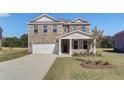 Attractive two-story brick home featuring a front-facing two car garage and inviting entryway at 136 Dalston Cv, Stockbridge, GA 30281