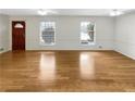 Bright living room with hardwood floors, fireplace, and a large window offering plenty of natural light at 2159 Pinehurst Rd, Snellville, GA 30078