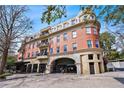 Elegant multi-story brick building featuring arched entryway, balconies, and manicured landscaping at 560 Dutch Valley Ne Rd # 2207, Atlanta, GA 30324