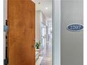 Apartment 2207 entryway featuring wood door opening to bright, modern hallway, and fresh decor at 560 Dutch Valley Ne Rd # 2207, Atlanta, GA 30324