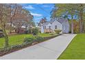 Quaint home featuring a long driveway and lush, green landscaping at 701 Daniel Ave, Decatur, GA 30032