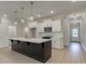 Modern kitchen featuring a large island, white cabinets, and stainless steel appliances at 179 Bluffington Way, Marietta, GA 30066