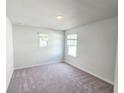 Bright bedroom with carpet flooring, two windows, and neutral paint at 2694 Mourning Dove Drive (Lot 35), Grayson, GA 30017