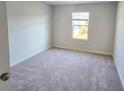 Bright bedroom featuring neutral carpet, a window, and fresh, neutral paint at 2694 Mourning Dove Drive (Lot 35), Grayson, GA 30017