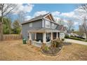 View of the side of a home with a covered porch and landscaping at 1699 Boulder Walk Se Dr, Atlanta, GA 30316