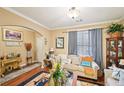 Cozy living room featuring hardwood floors, crown molding, and neutral paint at 1699 Boulder Walk Se Dr, Atlanta, GA 30316