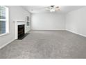Spacious living room with plush carpeting, fireplace, and bright natural light at 1882 Byrom Pkwy, Jonesboro, GA 30236
