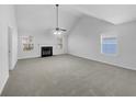 Bright living room featuring fireplace, vaulted ceiling, and oversized windows providing ample natural light at 1882 Byrom Pkwy, Jonesboro, GA 30236