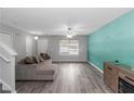 Spacious living room featuring gray walls, light vinyl floors, and ample natural light from large window at 2025 Shawn Wayne Se Cir, Atlanta, GA 30316