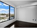 Bedroom with hardwood floors, large window, and natural light at 3445 Stratford Ne Rd # 1101, Atlanta, GA 30326