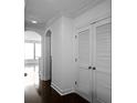 Hallway featuring hardwood floors, arched doorways, and closet space at 3445 Stratford Ne Rd # 1101, Atlanta, GA 30326