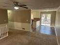 Open-concept living room and dining area leading to the kitchen, perfect for entertaining guests at 6625 Paula Ct, Lithonia, GA 30038