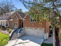 Side view of brick home with manicured lawn, two-car garage and beautiful stone staircase at 1244 Kingsley Ne Cir, Atlanta, GA 30324