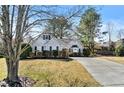 Inviting single-Gathering home featuring meticulous landscaping, a long driveway, and mature trees at 1325 Richland Creek Ct, Buford, GA 30518