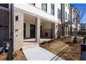 Townhome exterior with brick facade, a covered entrance, and well-maintained landscaping at 338 Olmstead Way # 35, Alpharetta, GA 30022