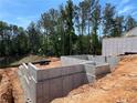 Image of a new home foundation with a concrete slab and framing set in a sunny outdoor location at 4375 Easter Lily Ave Lot 81, Buford, GA 30519