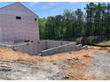 Image of a new home foundation with a concrete slab and framing set in a sunny outdoor location at 4375 Easter Lily Ave Lot 81, Buford, GA 30519