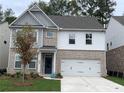 Beautiful brick and siding two-story home with a well-maintained lawn and a two-car garage at 4375 Easter Lily Ave Lot 81, Buford, GA 30519