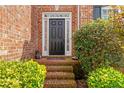 Close-up of the front door with brick steps and manicured landscaping at 8819 Lakecrest Way, Union City, GA 30291