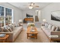 Bright living room featuring two sofas, decorative lamps, and a large picture window at 230 Nina Cir, Locust Grove, GA 30248