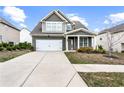Inviting two-story home with a clean driveway, manicured lawn, and a welcoming front porch area at 2466 Bear Mountain St, Lithonia, GA 30058