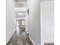 Elegant home foyer featuring soaring ceilings, beautiful hardwood floors, and a view into the spacious living area at 2466 Bear Mountain St, Lithonia, GA 30058