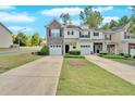 A well-manicured lawn highlights this lovely townhouse community with driveways and sidewalks at 258 Ridge Mill Dr, Acworth, GA 30102