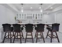 Finished basement bar features modern cabinets, stylish lighting, and comfortable bar stool seating at 3570 Mill Creek Drive Sw Dr, Smyrna, GA 30082