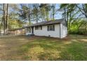 A well-maintained home with a clean, inviting exterior and lush green lawn at 7323 Howard Pl, Jonesboro, GA 30236