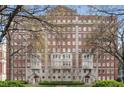 Beautiful brick apartment building with mature trees, manicured lawn and decorative entrance at 1325 Peachtree Ne St # 402, Atlanta, GA 30309