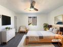 Bright bedroom offering a ceiling fan, a large window, and stylish decor at 4933 Bayside Ct, Stone Mountain, GA 30088