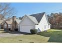 Beautiful home featuring light gray vinyl siding, a well-maintained lawn, and a convenient two-car garage at 1128 Strath Clyde Way, Mcdonough, GA 30253