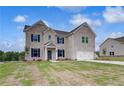 Charming two-story home featuring a well-manicured lawn and a spacious two-car garage at 111 Felicity Pike, Locust Grove, GA 30248