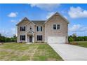 Charming two-story home featuring a well-manicured lawn and a spacious two-car garage at 111 Felicity Pike, Locust Grove, GA 30248