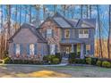 Beautiful two-story home featuring brick and stone exterior with manicured lawn at 205 Bergen Dr, Fayetteville, GA 30215