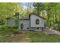 Two-story home with gray siding and a well-maintained front yard surrounded by mature trees at 1291 Marcelle Heights Pl, Norcross, GA 30093