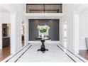 Elegant foyer with soaring ceilings, black accent wall and marble flooring at 350 Newcastle Dr, Alpharetta, GA 30009