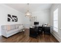 Bright home office featuring hardwood floors, a large desk and a comfortable sofa at 350 Newcastle Dr, Alpharetta, GA 30009