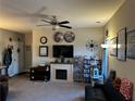 Inviting living room with a fireplace, ceiling fan, and cozy furnishings, perfect for relaxation and entertaining at 101 Waters Edge Pkwy, Temple, GA 30179