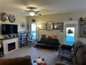 Cozy living room features a fireplace, ceiling fan, carpeted floors, and comfortable seating at 101 Waters Edge Pkwy, Temple, GA 30179